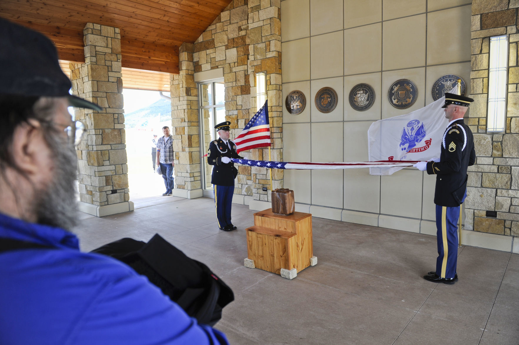 Sgt. 1st Class Matt Foster, right, and Master Sgt. Jesse Edinger fold an American Flag